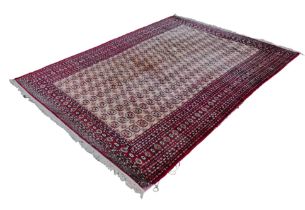 A large Tekke carpet, with eight rows of twenty-eight guls on a cream ground, with multiple red