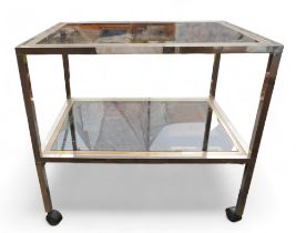 A rectangular glass topped two-tier trolley with silver / brass edge.