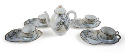 A Japanese porcelain part tea service, with coffee pot, 18.5cm high, four cups and four unusual