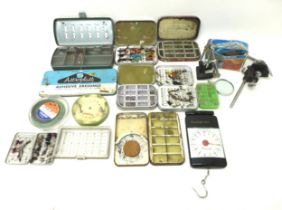 A collection of assorted fly fishing flies and fly making equipment.