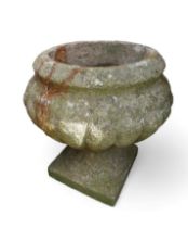 A cast concrete garden urn on Pedestal and square base.