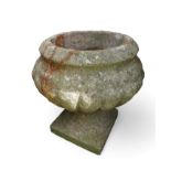 A cast concrete garden urn on Pedestal and square base.