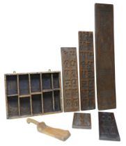 A collection of wooden biscuit moulds, largest, 101cm long, together with a country made spice rack.