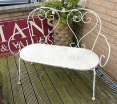 A white metal garden bench with solid seat.