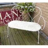 A white metal garden bench with solid seat.