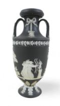 A small Wedgwood black jasper ware twin handle vase 6cm diameter by 13cm tall. One minor mark/chip