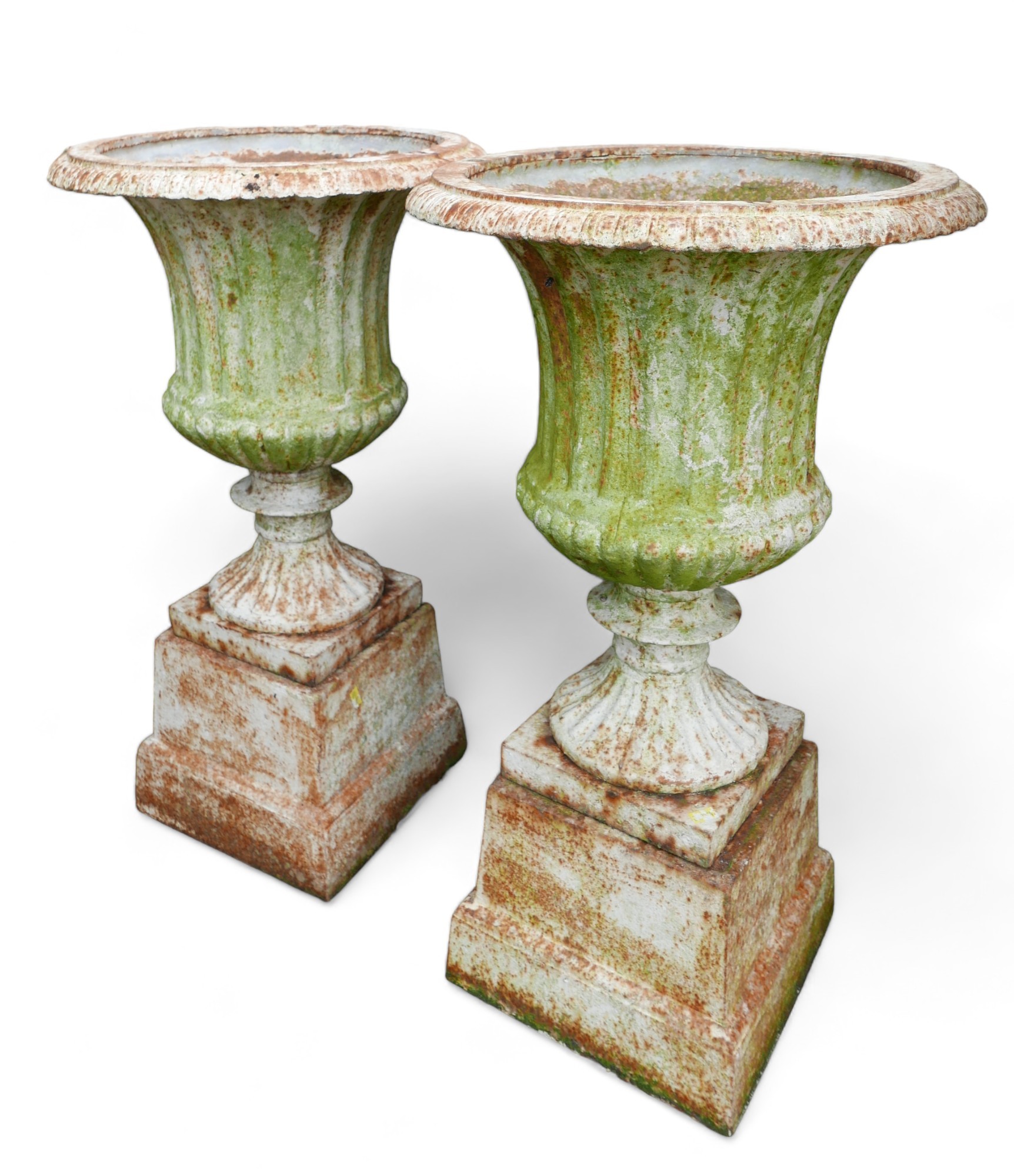 A pair of cast iron fluted garden urns on pedestals with square bases. (2)