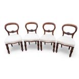A set of four 19th century mahogany balloon back dining chairs on turned reeded front legs. (4)