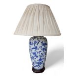 An Oriental style blue and white table lamp with shade, 56cm by 83cm tall.