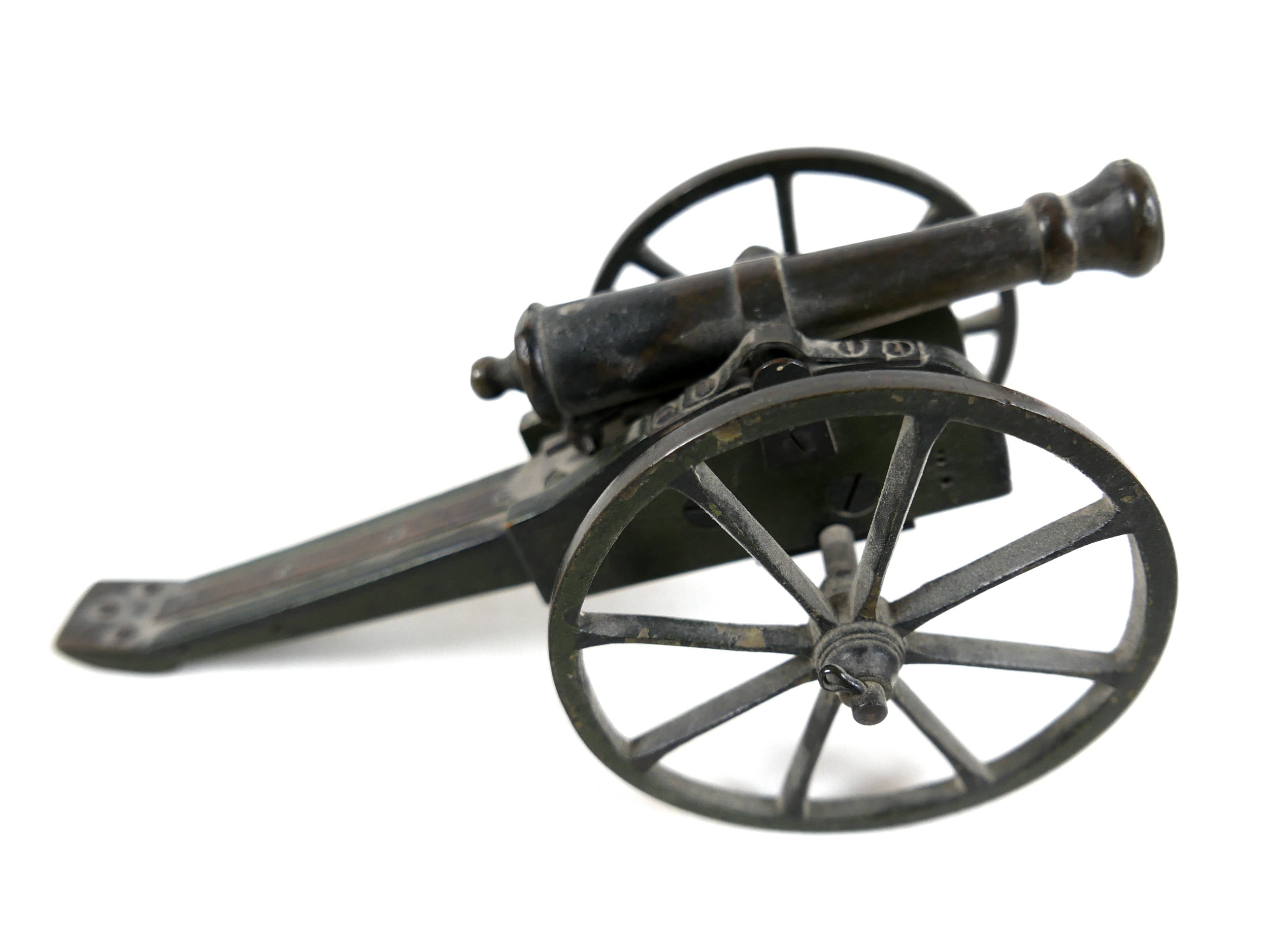 A miniature bronze canon, probably French 19th century, on wooden carriage with cast metal wheels,