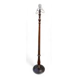 A mahogany standard lamp, part reeded, turned column on circular base.