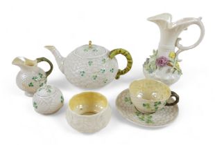 Seven pieces of Belleek porcelain including a teapot, various marks. (7) Floral encrusted jug has