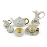 Seven pieces of Belleek porcelain including a teapot, various marks. (7) Floral encrusted jug has