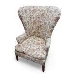 An early 19th century mahogany fan back library chair upholstered in a regency style foliate fabric,