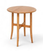 An Ercol blonde elm side table, with circular top, model 1207, 60 by 60 by 73cm tall. Good