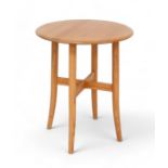 An Ercol blonde elm side table, with circular top, model 1207, 60 by 60 by 73cm tall. Good