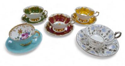 A group of three Paragon china cabinet cups and saucers, and one Aynsley, variously coloured,
