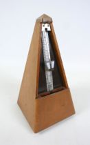 A French metronome by Paquet, 11cm by 11cm by 22cm tall. In working order.