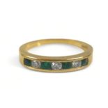 A seven-stone emerald and diamond ring, comprising three diamonds and four emeralds on 750 / 18ct