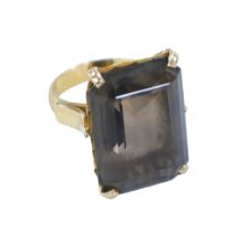 An 18ct gold smoky quartz ring, the rectangular cut stone 16 by 22mm, size n, 11.9g.