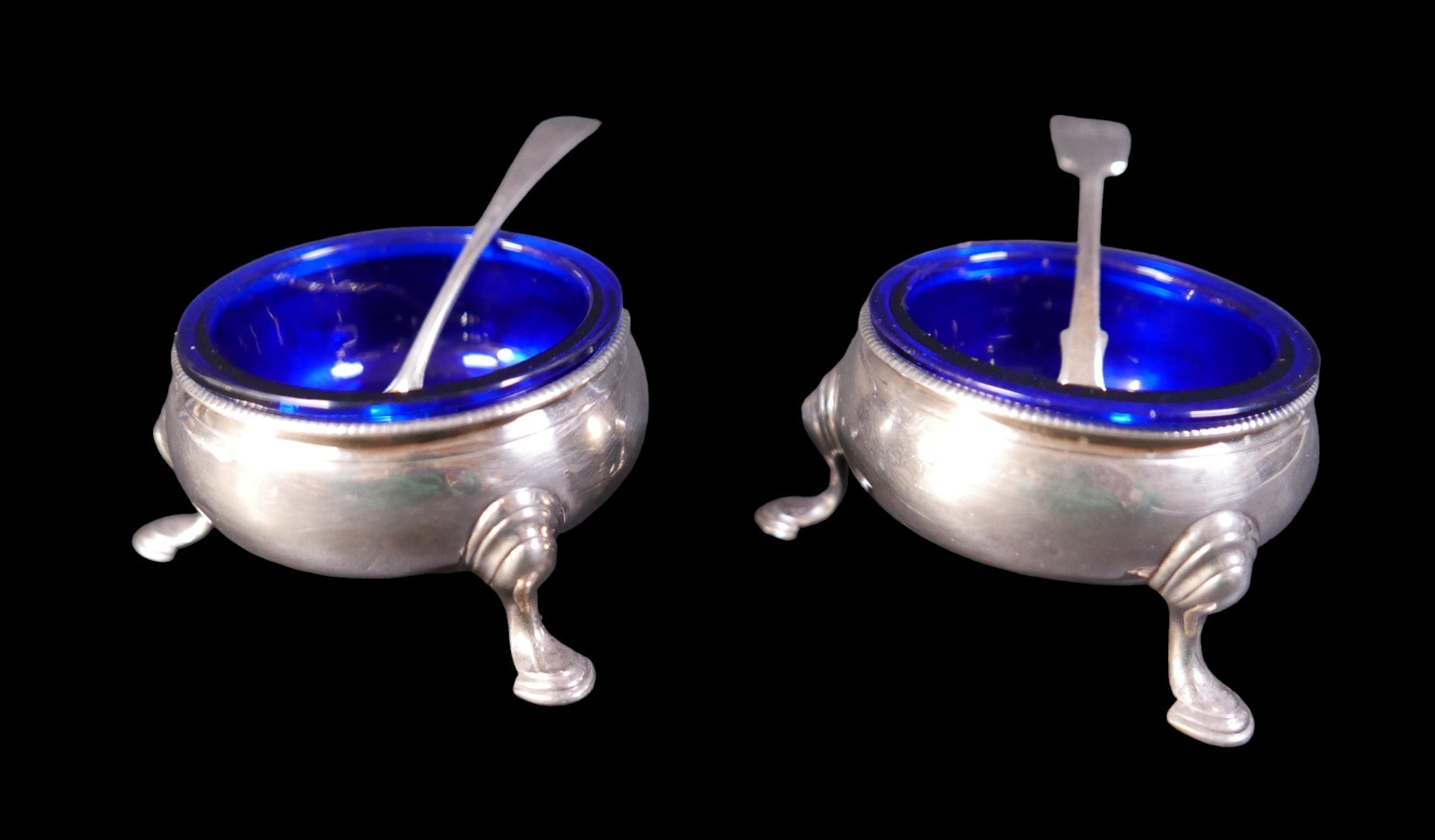 A pair of Georgian silver salts, London 1762/63 with associated silver spoons and replacement