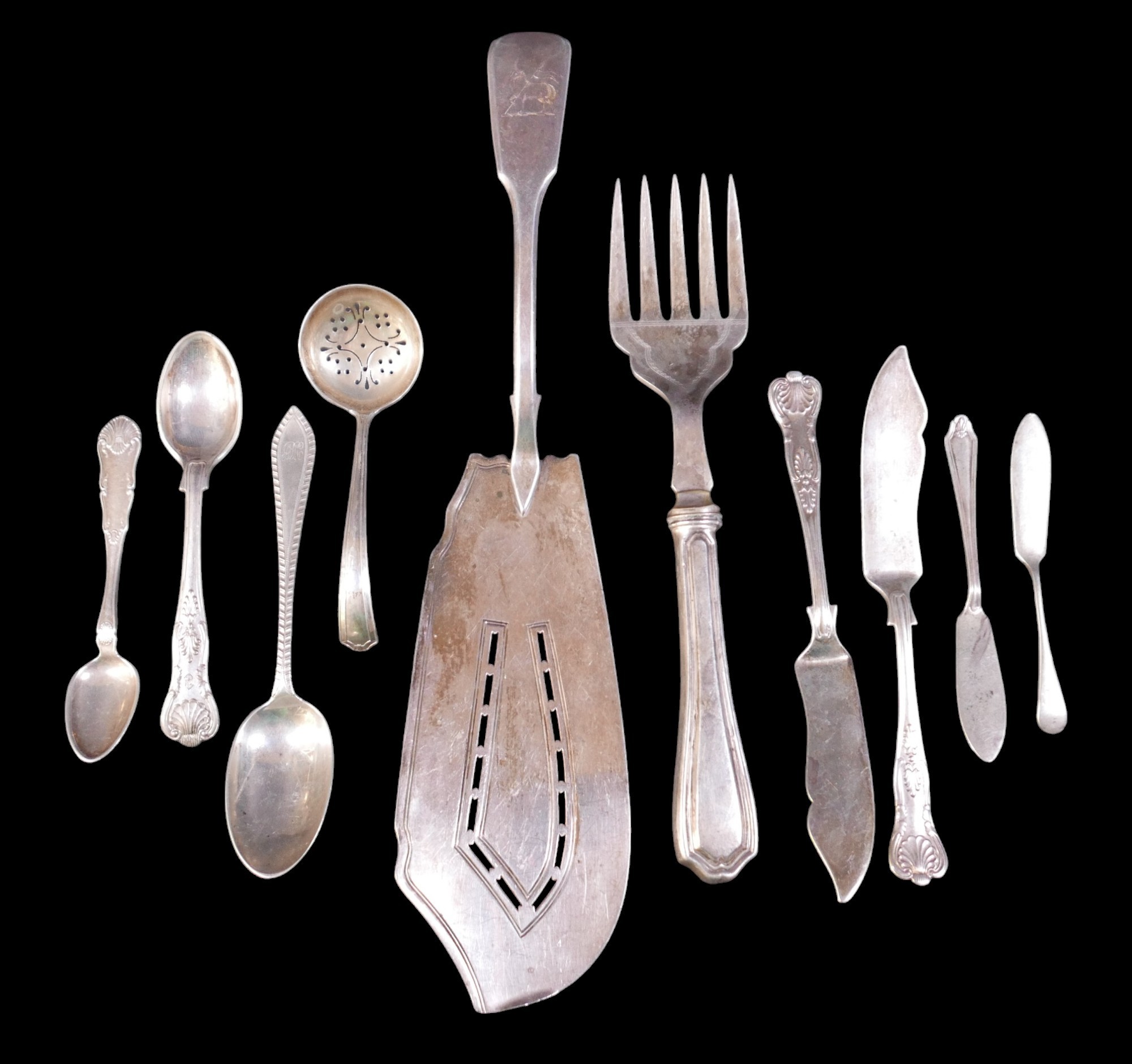 A group of silver flatware, comprising a George III silver fish slice, with lamb and pennant