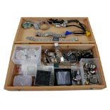 A collection of assorted watch repairing tools, straps, movements, and parts.