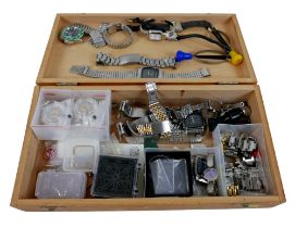 A collection of assorted watch repairing tools, straps, movements, and parts.