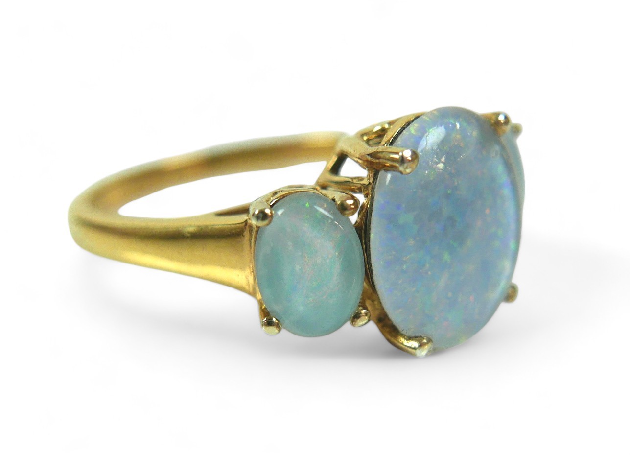 A group of three dress rings, comprising a three stone opal ring, largest stone 12.02 by 10.16mm, - Image 2 of 13