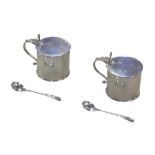 A pair of George V silver condiment pots, with hinged lids and clear glass liners, Walter H