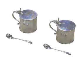 A pair of George V silver condiment pots, with hinged lids and clear glass liners, Walter H