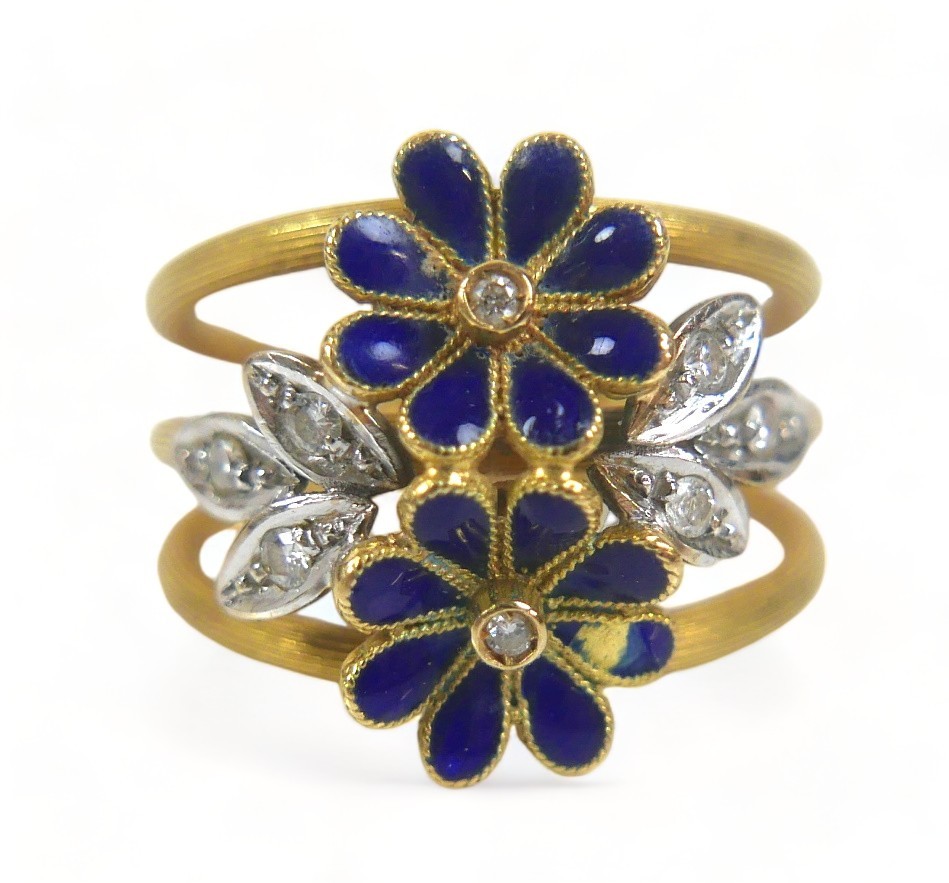 A diamond and enamel flower head ring, with eight small diamonds, the band stamped '750', size M,