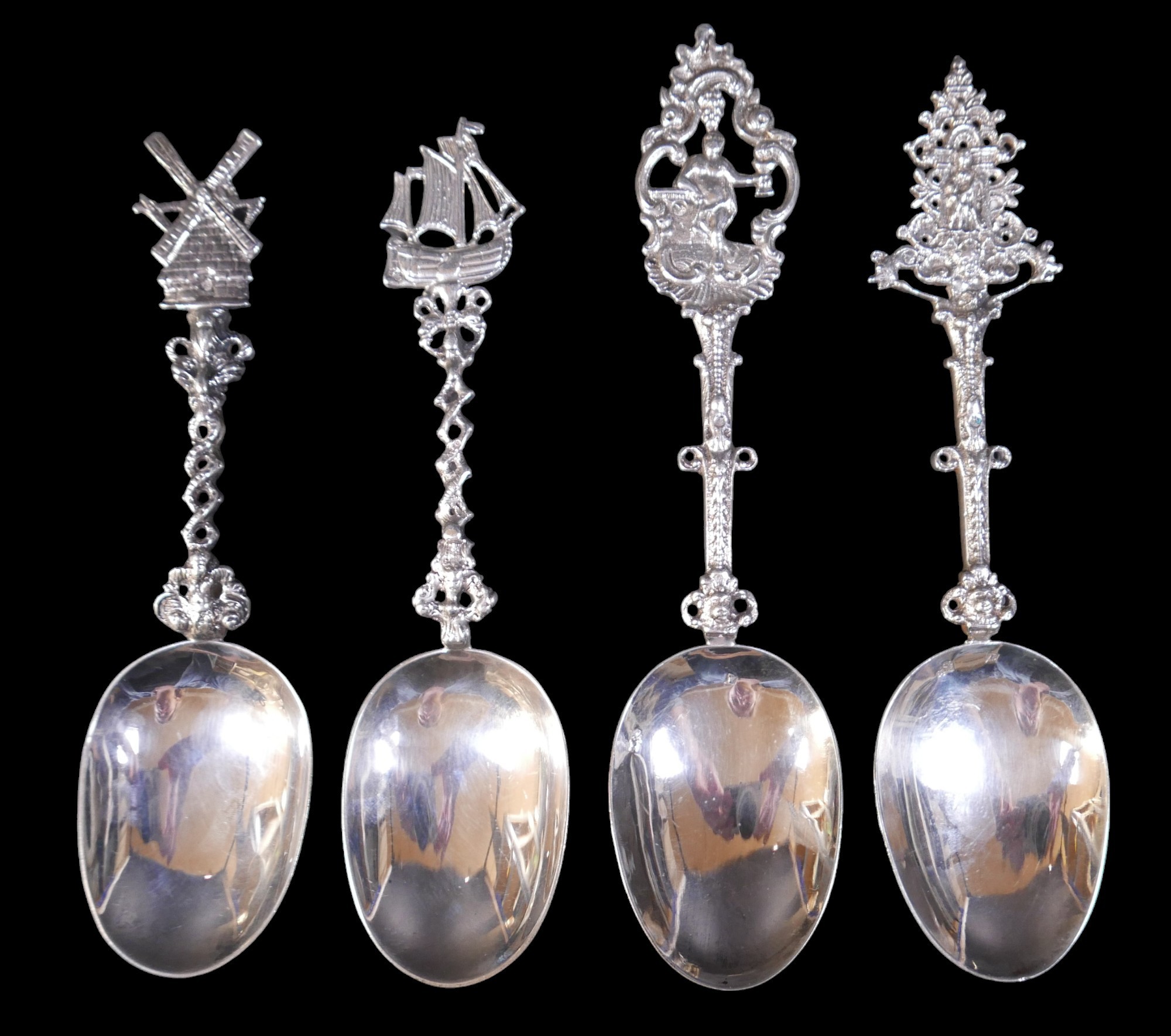 Four Dutch silver spoons with decorative finials (possibly earlier bowls with later handles) with