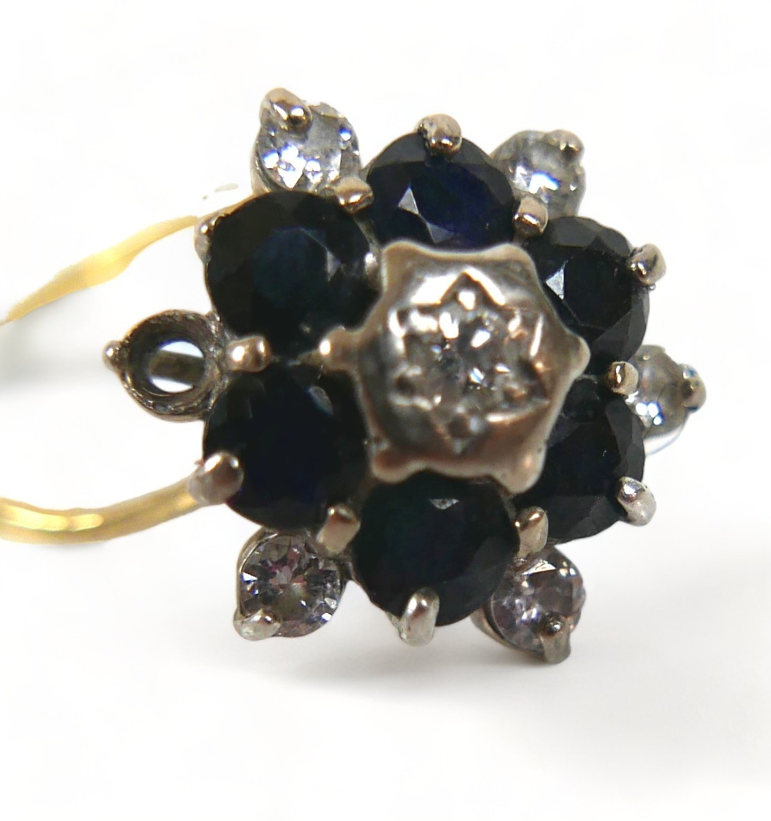 A 18ct diamond and sapphire flowerhead ring, (missing one diamond a/f), with six brilliant-cut - Image 3 of 5