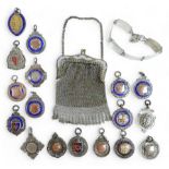 A collection of seventeen medallion fobs, a silver bracelet and a white metal purse, gross weight