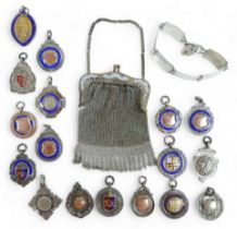 A collection of seventeen medallion fobs, a silver bracelet and a white metal purse, gross weight