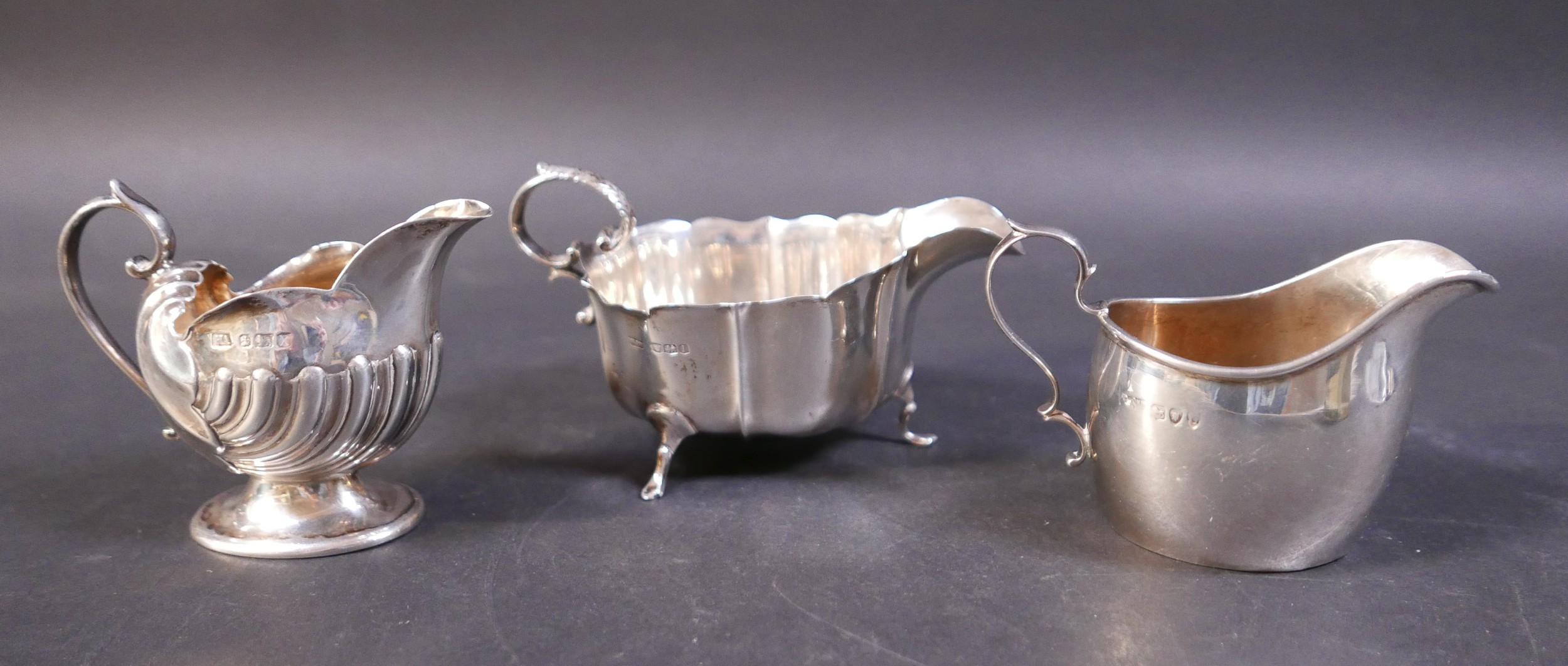 Three small silver jugs, comprising Mappin and Webb jug with three pad feet, Sheffield 1951, a small