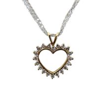 A 15ct gold and diamond heart shaped pendant, set with twenty brilliant cut diamonds, on a 15ct
