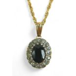 An oval sapphire and diamond flowerhead pendant on gold chain, the chain testing as 9ct, 2.8g,