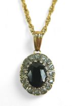 An oval sapphire and diamond flowerhead pendant on gold chain, the chain testing as 9ct, 2.8g,