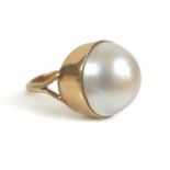 A 9ct gold ring set with a large cabochon pearl, approximately 15 mm diameter, size K, 6.9g.