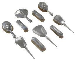 Two sets of silver backed dressing table brushes and hand mirrors, including a set of five, with