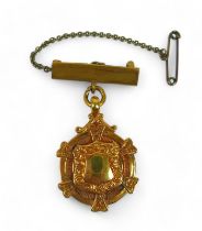 A 9ct gold presentation medal, on yellow metal pin with safety chain, gross weight 7.4g.