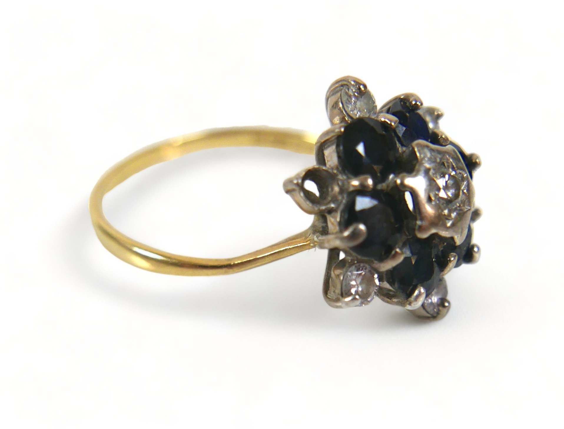 A 18ct diamond and sapphire flowerhead ring, (missing one diamond a/f), with six brilliant-cut - Image 2 of 5