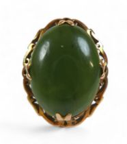 A yellow gold jade ring, size N, head size 24 by 11 by 19mm, 5.9g.