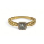 A diamond solitaire ring, the princess cut stone on gold band, size J.