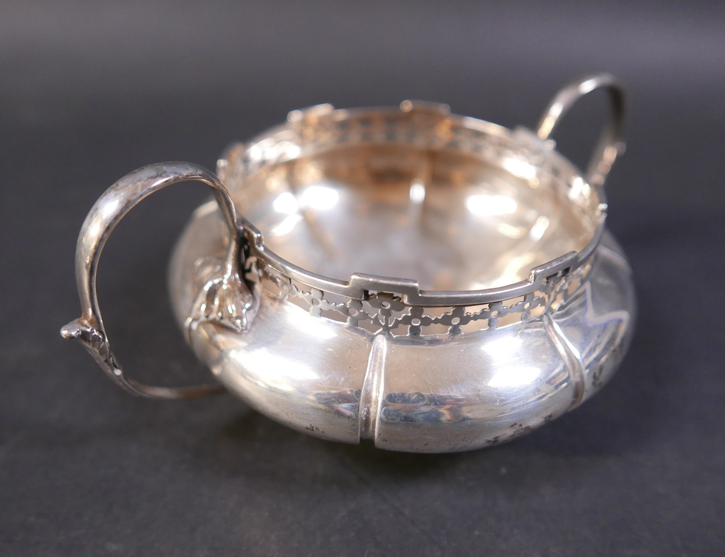 An Edwardian silver three piece tea set, decorated with a pierced rim, stamped 'Reg No 6136058', - Image 7 of 8