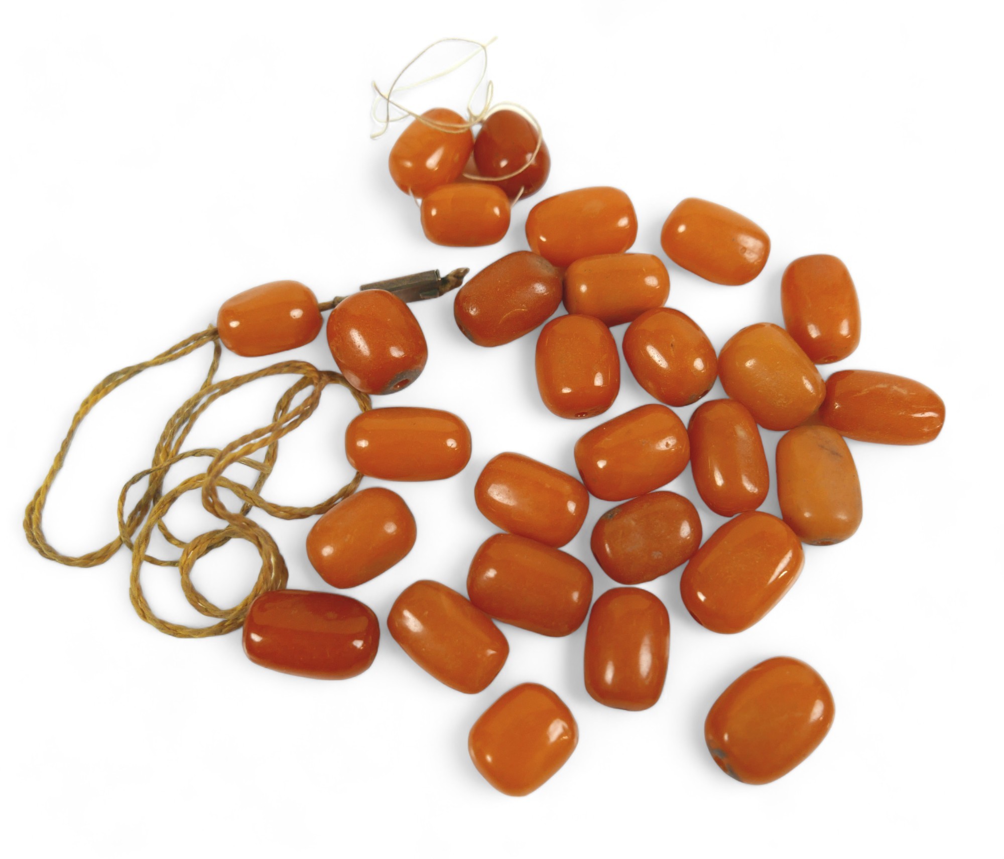 A collection of butterscotch amber oval beads, approx. 35g total, most 16mm long (28 total). (1 bag)