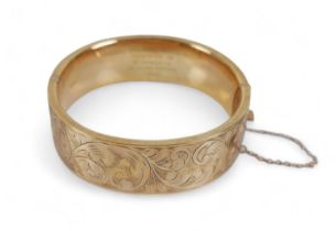 A 9ct yellow gold presentation engraved hinged bangle, 25.1 grams. 60mm by 63mm by 19mm external. In