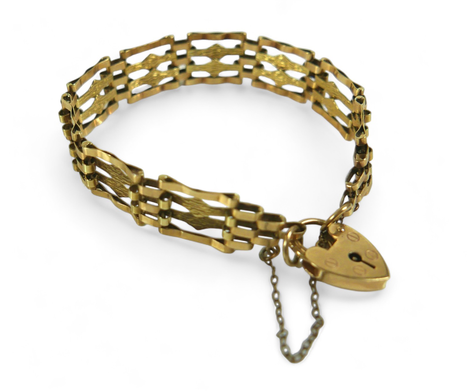 A 9ct gold bar gate bracelet with heart shaped lock and central textured bands, 10.6g.